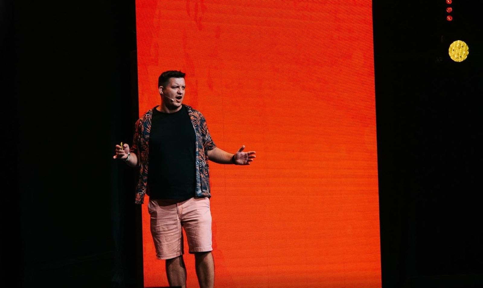 Lazar speaking on stage